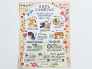 ままぎん ママの日フェスのポスター、2026年5月10日に市川真間駅構内で開催、地元グルメや耳つぼジュエリー体験、京成電鉄や真間銀座会の紹介を掲載（2026年4月30日筆者撮影）
